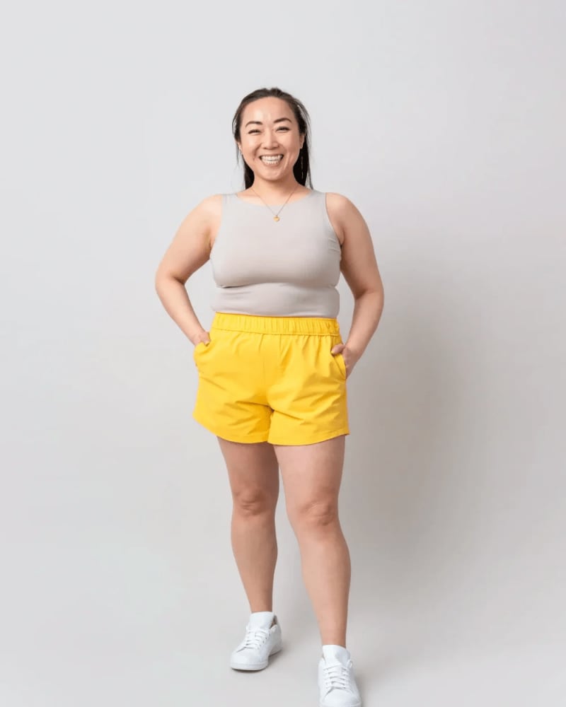 Front of a model wearing a size L surf's up shorts (5") in Banana by alder apparel. | dia_product_style_image_id:301386